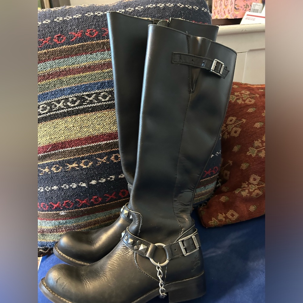Black John Fluevog boots with chain detail.